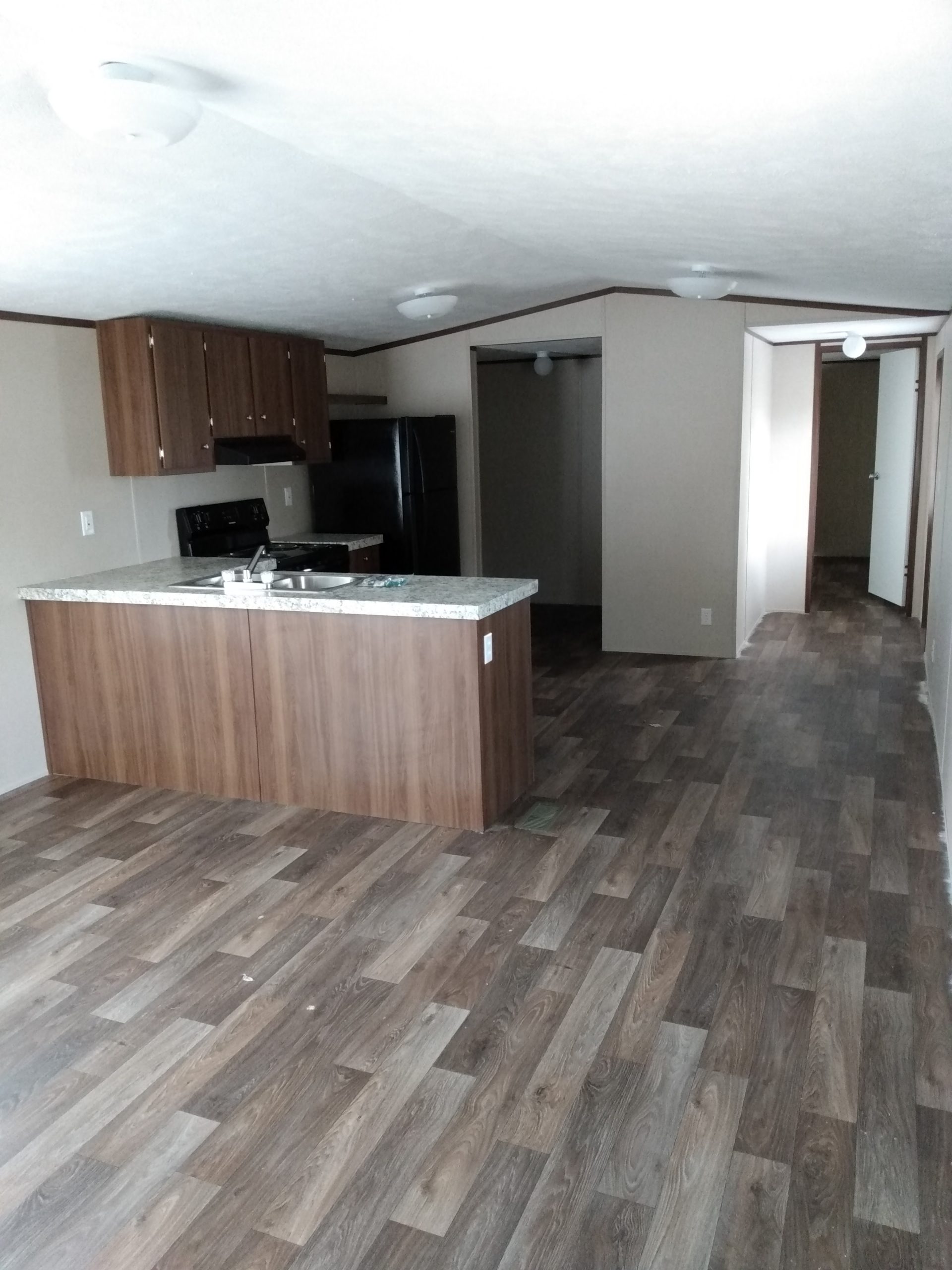 Kitchen with a counter island and open living area